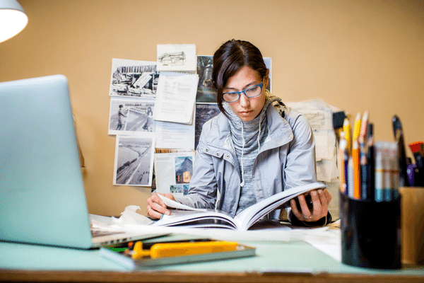 OHSU-PSU SPH student reading a scientific research journal