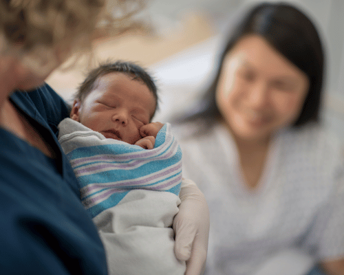 Lactation Consultant holding a baby