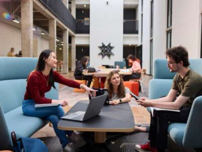 OHSU-PSU School of Public Health undergraduate public health minor students studying at a table in with laptops and books open