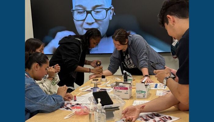 Students in the Tilikum Summer Health Experience program create simulated injuries to practice dressing the wounds.