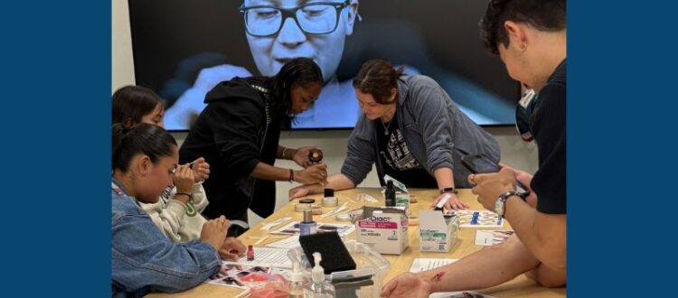 Students in the Tilikum Summer Health Experience program create simulated injuries to practice dressing the wounds.