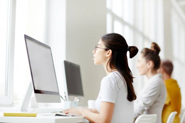 OHSU-PSU School of Public Health Master of Public Health student taking the online annual student survey from a computer in the library