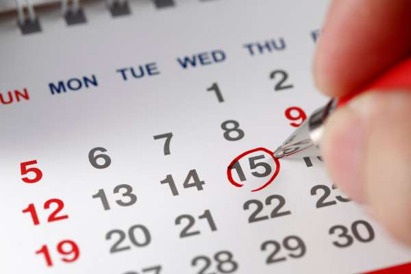 OHSU-PSU School of Public Health Student circling a date in their calendar with a red pen