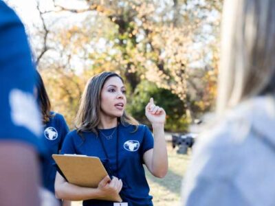 Food Systems Equity Program Manager speaking with volunteers at a park