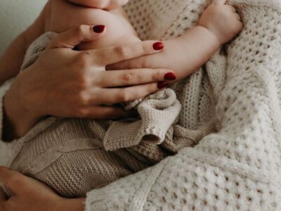 Mother holding baby with infant allergies