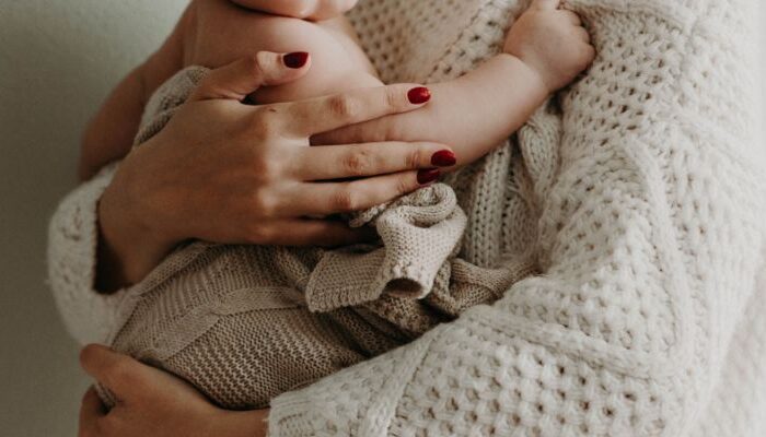 Mother holding baby with infant allergies