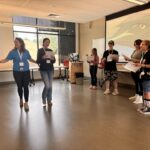 Rural Public Health Initiative Summer Camp Counselor and Student interacting in educational activity.