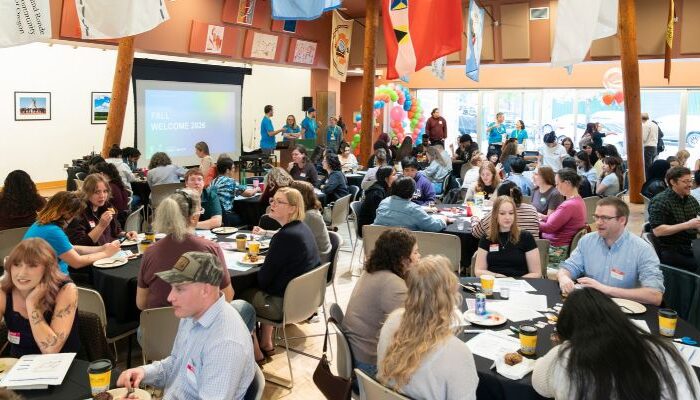OHSU-PSU School of Public Health Students Attending the Fall Welcome. Graduate and Undergraduate Students Sitting at Tables discussing public health topics and lived experiences together