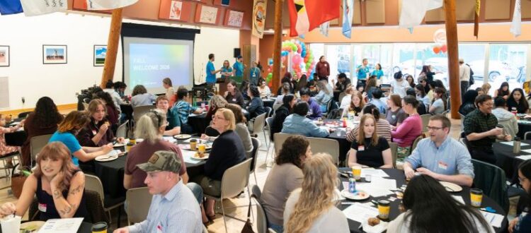 OHSU-PSU School of Public Health Students Attending the Fall Welcome. Graduate and Undergraduate Students Sitting at Tables discussing public health topics and lived experiences together