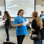 Rural Public Health Initiative Summer Camp Counselor and Student interacting in educational activity. Asking questions to each other
